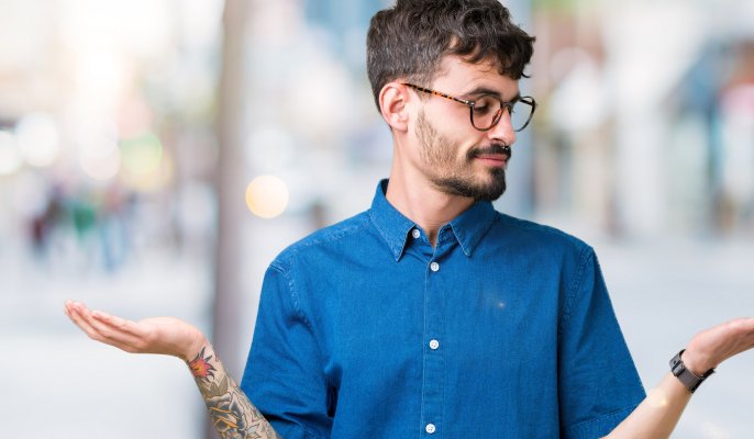 reimage plus advanced system repair comparison system optimizer man with glasses and blue shirt weighing options with his hands